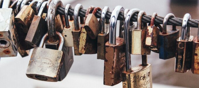 shallow focus photography of padlocks in steel cable